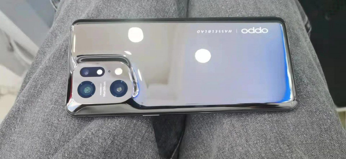 Oppo Find X5 Pro poses for camera with reflective back
